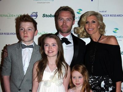 Ronan Keating is wearing a tuxedo, Yvonne Connolly is wearing black dress, Jack is wearing grey suit, and Missy and Ali is wearing a white dress.